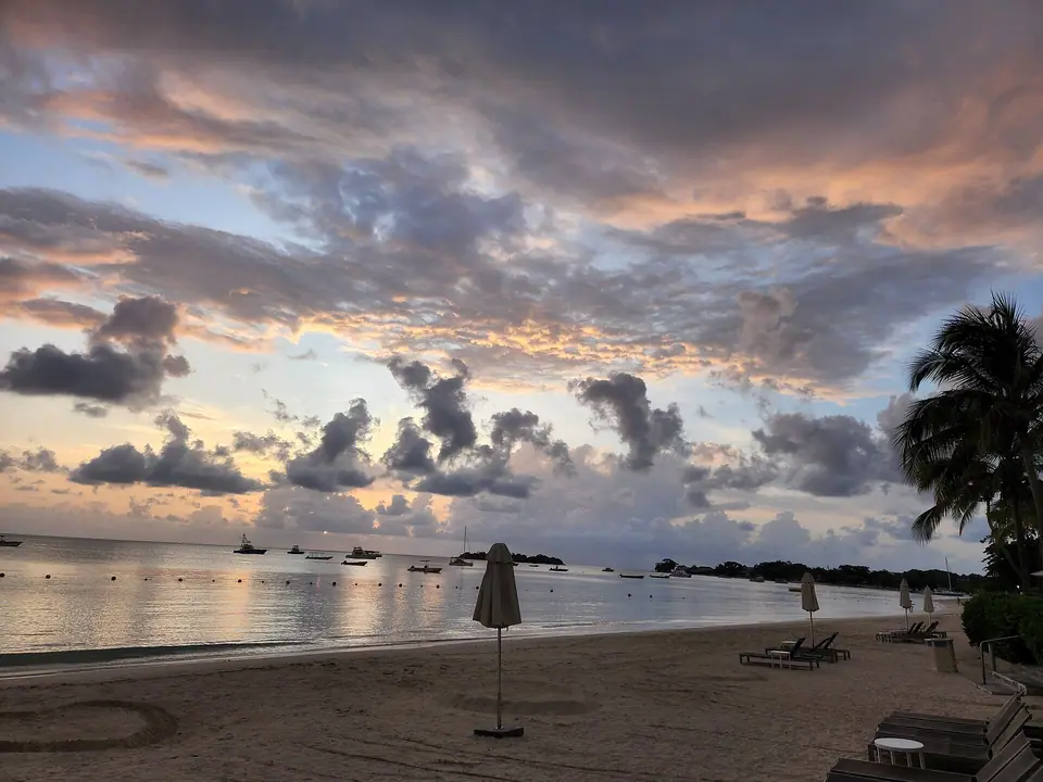 Seven Mile Beach in Negril, Jamaica, with palm trees, white sand and turquoise water