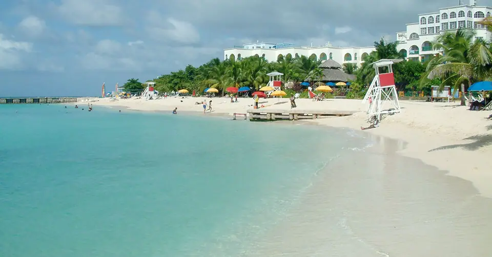 Turquoise water and white sand at Doctor's Cave Beach in Montego Bay with a lifeguard stand